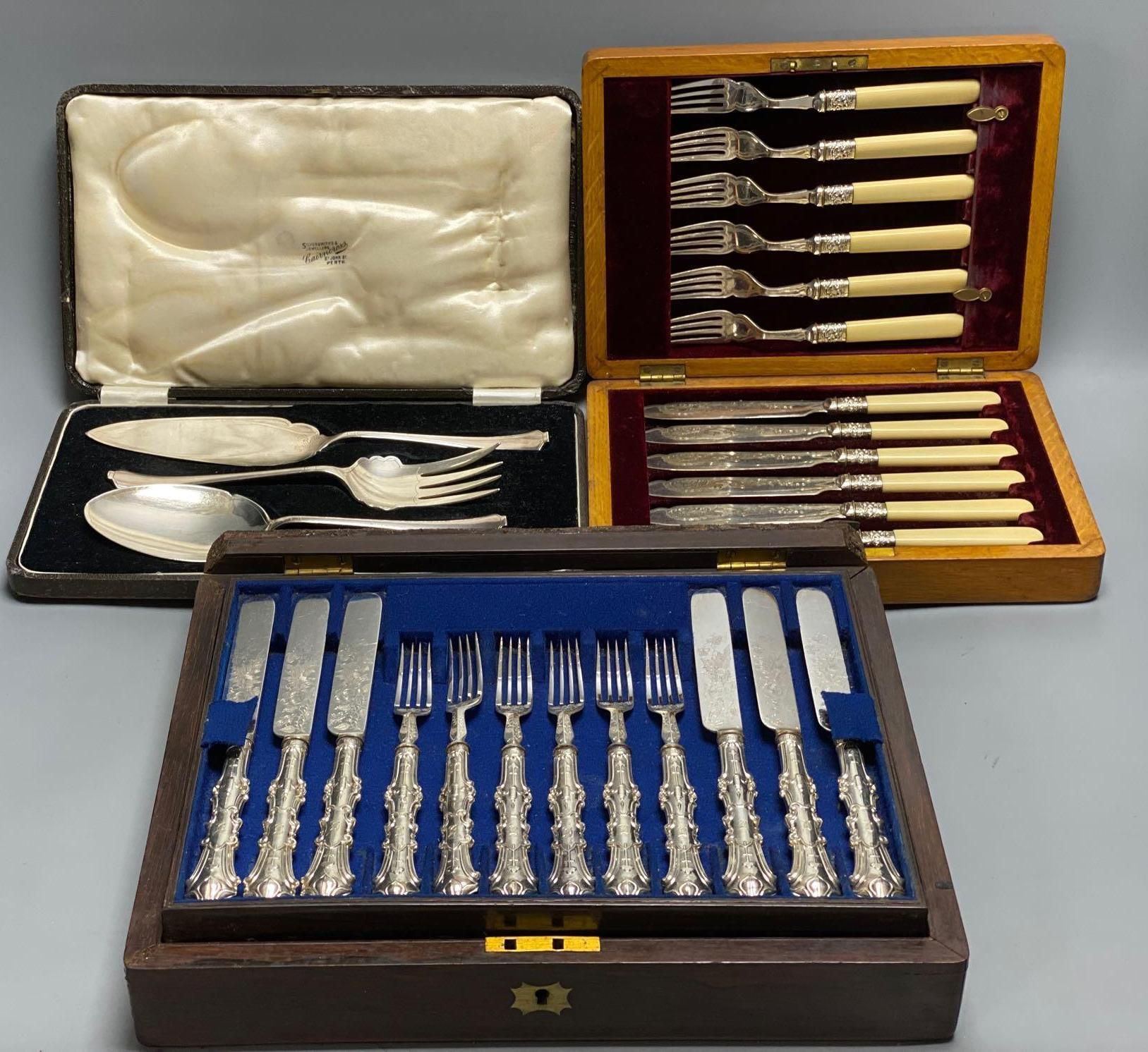 A Victorian rosewood cased set of eighteen plated dessert knives and forks, and two other cased sets of plated cutlery